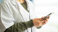 Doctor using mobile phone at the clinic.